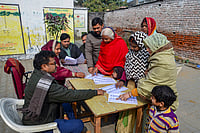 | Photo: PTI : People search for their names in the draft voter list after the Special Intensive Revision of electoral rolls in Uttar Pradesh, in Mirzapur, Uttar Pradesh.