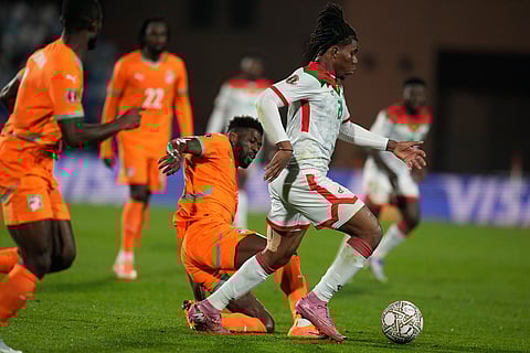 Ivory Coast's Ibrahim Sangare, left, challenges Burkina Faso's Irie Bi during the Africa Cup of Nations best of 16 soccer match between Ivory Coast and Burkina Faso in Marrakech, Morocco.