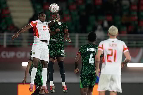 Mozambique's Chamito Alfandega, left, and Nigeria's Calvin Bassey challenge for the ball during the Africa Cup of Nations round of 16 soccer match between Nigeria and Mozambique in Fez, Morocco.