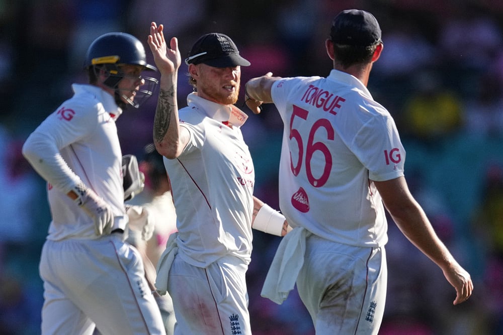 England's Ben Stokes gestures to teammate Josh Tongue, right, as they leave the field on day three of the fifth and final Ashes cricket test between England and Australia in Sydney. - | Photo: AP/Mark Baker