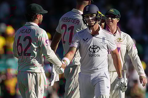 England's Jacob Bethell is congratulated on his century by Australia's Travis Head, left, as he walks from the field at the close of play during on day four of the fifth and final Ashes cricket test between England and Australia in Sydney.