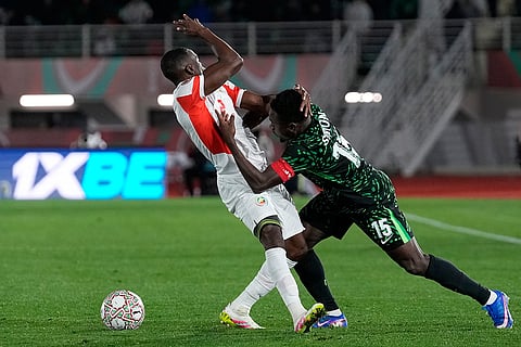 Nigeria's Moses Simon, right, and Mozambique's Infren Matola challenge for the ball during the Africa Cup of Nations round of 16 soccer match between Nigeria and Mozambique in Fez, Morocco.