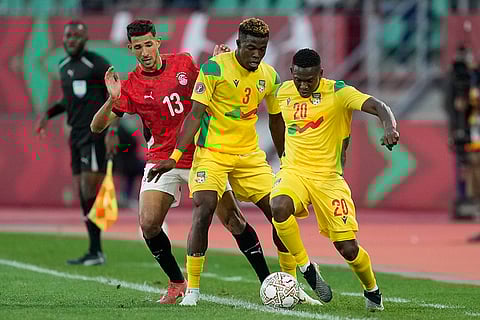 Benin's Jodel Dossou, right, controls the ball as his teammate Tamimou Ouorou stops Egypt's Ahmed Abou El Fatouh during the Africa Cup of Nations round of 16 soccer match between Egypt and Benin in Agadir, Morocco.