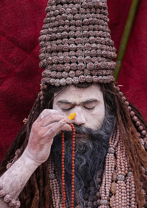 A Naga sadhu of the Niranjani Akhara on the banks of Sangam during the 'Magh Mela' festival, in Prayagraj.
