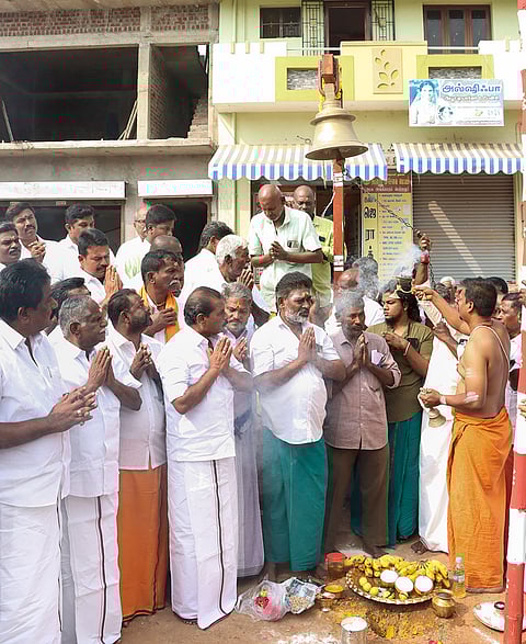 Tamil Nadu Commercial Taxes and Registration Minister P Moorthy, left, and others offer prayers during the ‘bhoomi pooja’ function for ‘Jallikattu’, in Madurai district, Tamil Nadu.