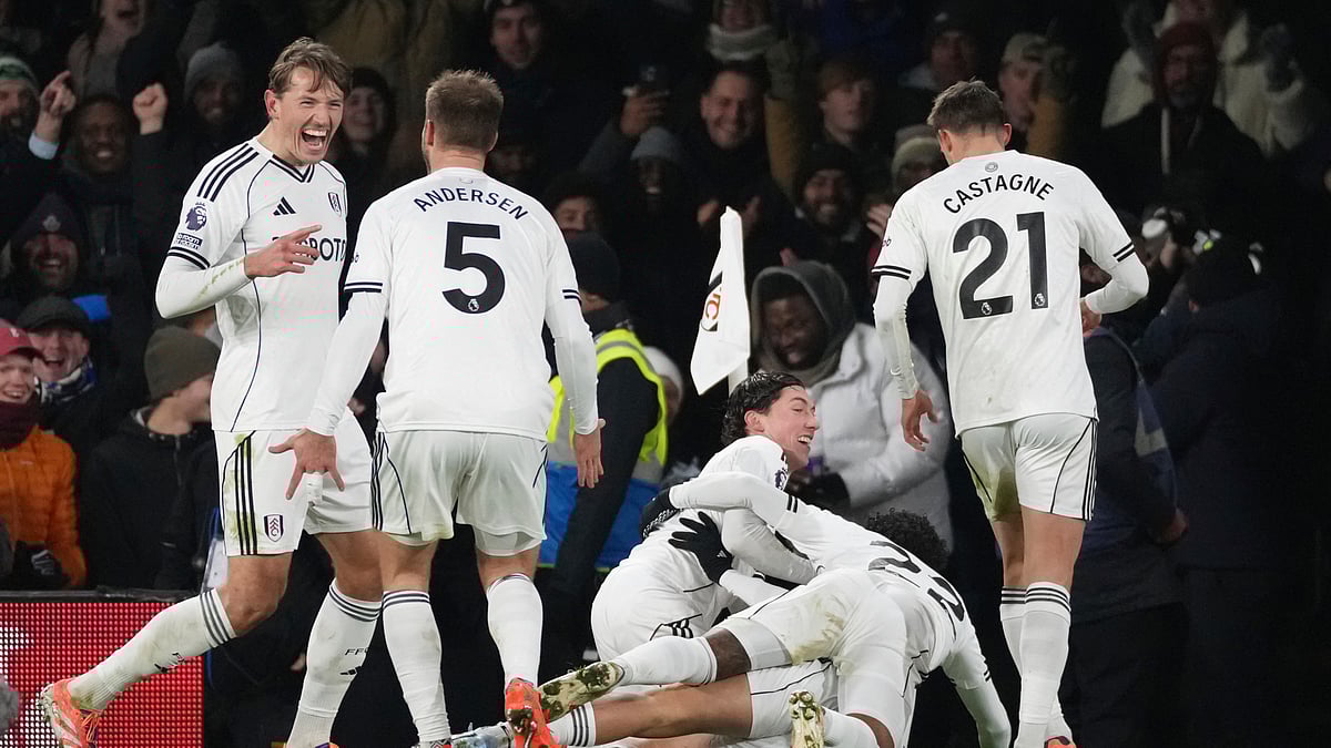Fulham's Raul Jimenez, bottom covered, celebrates with teammates after scoring the opening goal during the English Premier League soccer match between Fulham and Chelsea in London, Wednesday, Jan. 7, 2026. - (AP Photo/Dave Shopland)