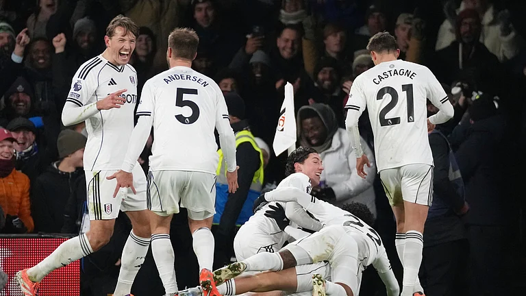 Fulham's Raul Jimenez, bottom covered, celebrates with teammates after scoring the opening goal during the English Premier League soccer match between Fulham and Chelsea in London, Wednesday, Jan. 7, 2026. - (AP Photo/Dave Shopland)