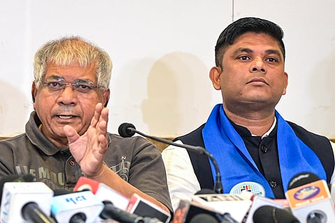 Vanchit Bahujan Aaghadi President Prakash Ambedkar, left, addresses a press conference, in Nagpur, Maharashtra.