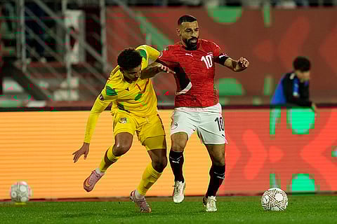 Egypt's Mohamed Salah, right, and Benin's Matteo Ahlinvi fight for the ball during the Africa Cup of Nations round of 16 soccer match between Egypt and Benin in Agadir, Morocco.
