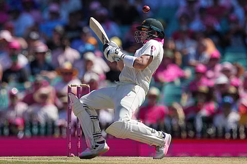Australia's Steve Smith reacts as he avoids a bouncer during play on day three of the fifth and final Ashes cricket test between England and Australia in Sydney.