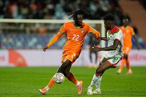 Burkina Faso's Edmond Tapsoba, right, challenges Ivory Coast's Evann Guessand during the Africa Cup of Nations best of 16 soccer match between Ivory Coast and Burkina Faso in Marrakech, Morocco.