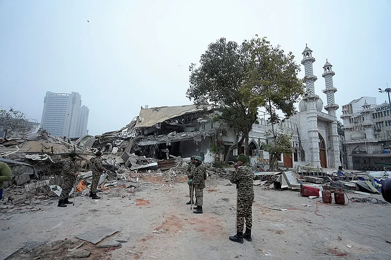 Security personnel stand guard outside the Syed Faiz Elahi mosque after the demolition of alleged encroachments from a land adjoining the mosque carried out by the Municipal Corporation of Delhi (MCD), at Turkman Gate area, in New Delhi. - | Photo: PTI/Shahbaz Khan