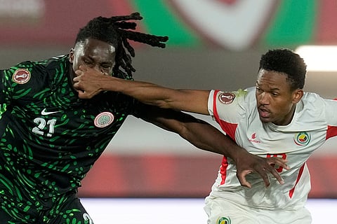Mozambique's Geny Catamo, right, and Nigeria's Calvin Bassey challenge for the ball during the Africa Cup of Nations round of 16 soccer match between Nigeria and Mozambique in Fez, Morocco.