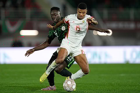Mozambique's Reinildo Mandava, front, and Nigeria's Akor Adams challenge for the ball during the Africa Cup of Nations round of 16 soccer match between Nigeria and Mozambique in Fez, Morocco.