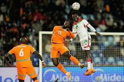 Ivory Coast's Jean-Philippe Krasso challenges Burkina Faso's Saidou Simpore, right, during the Africa Cup of Nations best of 16 soccer match between Ivory Coast and Burkina Faso in Marrakech, Morocco.