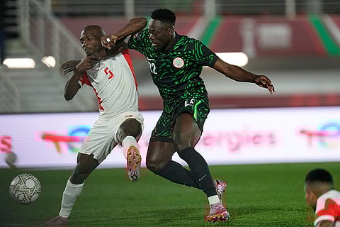 Mozambique's Bruno Langa, left, and Nigeria's Akor Adams challenge for the ball during the Africa Cup of Nations round of 16 soccer match between Nigeria and Mozambique in Fez, Morocco.