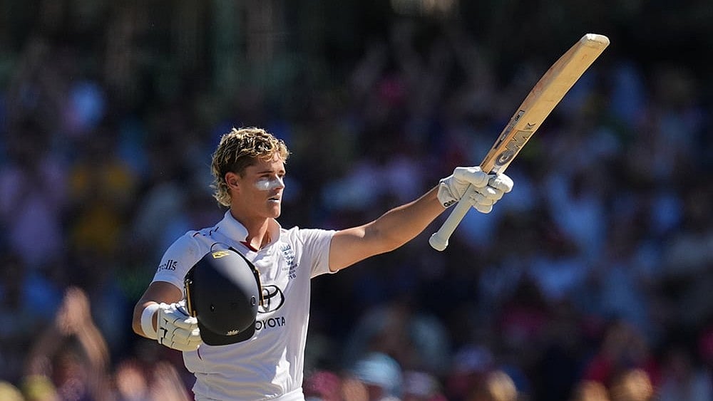 England's Jacob Bethell celebrates after scoring a century during play on day four of the fifth and final Ashes cricket test between England and Australia in Sydney. - | Photo: AP/Mark Baker