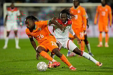 Burkina Faso's Issa Kabore, right, challenges Ivory Coast's Yan Diomande during the Africa Cup of Nations best of 16 soccer match between Ivory Coast and Burkina Faso in Marrakech, Morocco.