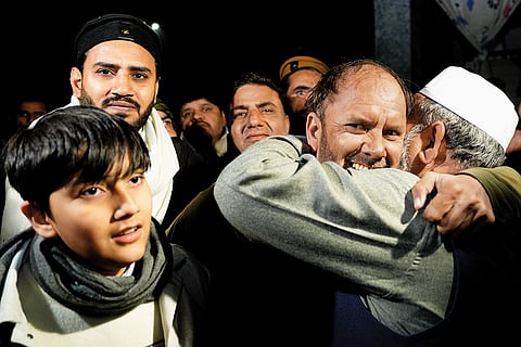 Shifa Ur Rehman is embraced by friends and relatives after his release from prison.