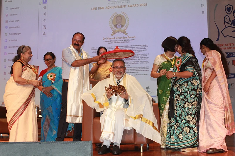 Dr. Nomal Chandra Borah seated and receiving the award