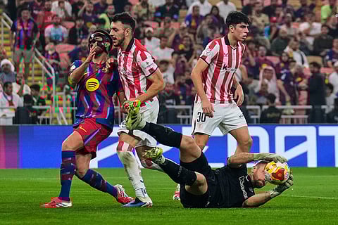 Athletic Bilbao's goalkeeper Unai Simon saves the Spanish Super Cup semifinal soccer match against FC Barcelona at King Abdullah Sports City Stadium in Jeddah, Saudi Arabia.