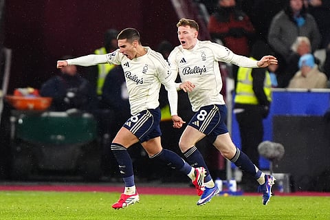 Nottingham Forest's Nicolas Dominguez, left, celebrates scoring during the English Premier League soccer match between West Ham United and Nottingham Forest in London.