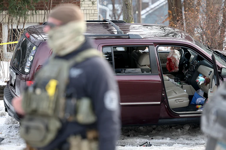 A deployed airbag and blood stains are seen in a crashed vehicle on at the scene of a shooting in Minneapolis on Wednesday, Jan. 7, 2026. - Ellen Schmidt
