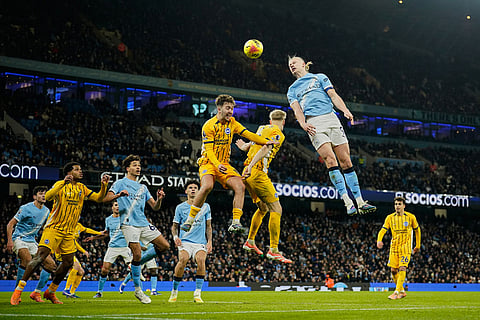 Manchester City's Erling Haaland attempts a head at goal during the English Premier League soccer match between Manchester City and Brighton and Hove Albion in Manchester, England.