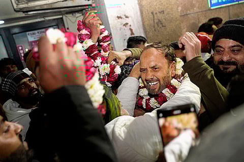 Shifa Ur Rehman is welcomed by family members with garlands.
