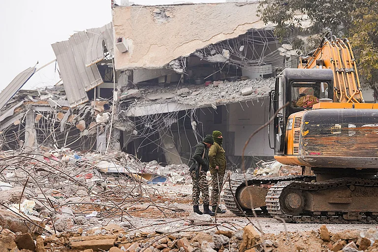 Security personnel stand guard near the Syed Faiz Elahi mosque after the demolition of alleged encroachments on land adjoining the mosque, carried out by the Municipal Corporation of Delhi (MCD), in the Turkman Gate area of New Delhi. - | Photo: PTI/Ravi Choudhary