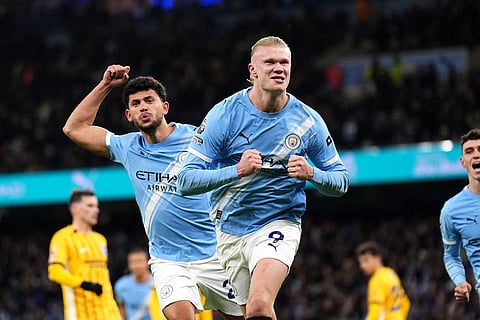 Manchester City's Erling Haaland celebrates scoring their side's first goal of the game during the English Premier League soccer match between Manchester City and Brighton and Hove Albion in Manchester, England.