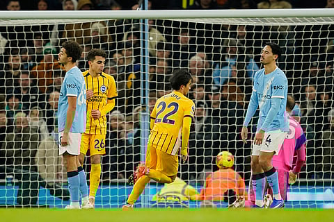 Brighton's Kaoru Mitoma, center, celebrates after scoring his side's opening goal during the English Premier League soccer match between Manchester City and Brighton and Hove Albion in Manchester, England.