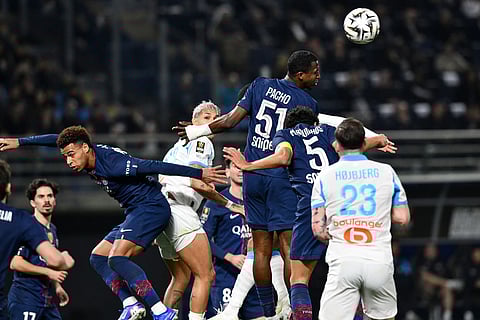 PSG's Willian Pacho heads the ball clear during the French Super Cup soccer match between PSG and Marseille in Kuwait City, Kuwait.