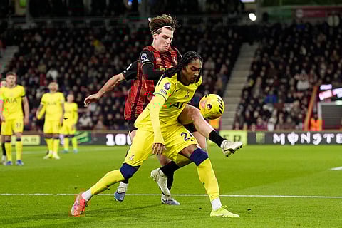 Bournemouth's Alex Scott and Tottenham Hotspur's Djed Spence battle for the ball during the English Premier League soccer match between Bournemouth and Tottenham Hotspur in Bournemouth, England.