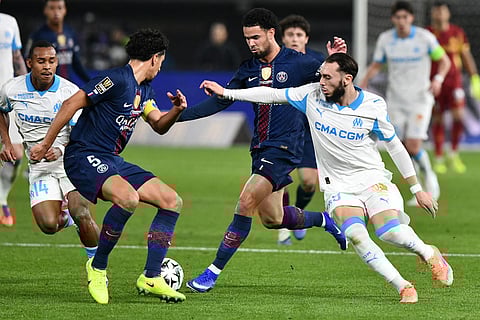 Marseille's Amine Gouiri, right, and PSG's Marquinhos, left. battle for the ball during the French Super Cup soccer match between PSG and Marseille in Kuwait City, Kuwait.