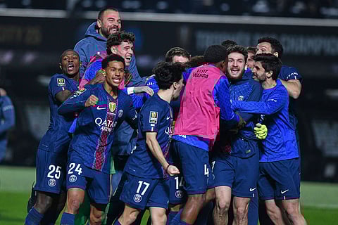 PSG players celebrate after a penalty shootout to win the French Super Cup soccer match between PSG and Marseille in Kuwait City, Kuwait.