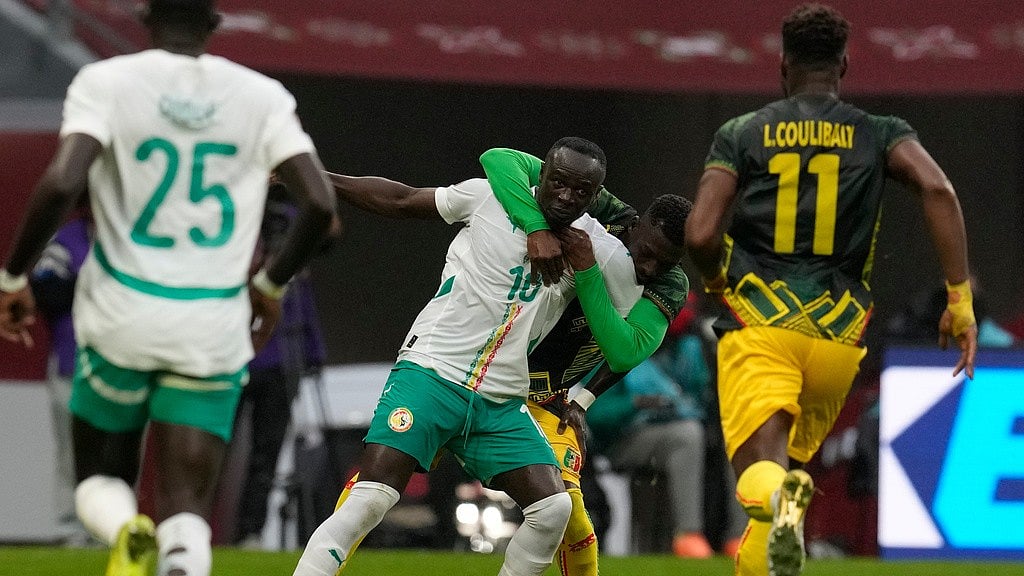 Mali's Hamari Traore, background, holds Senegal's Sadio Mane during the Africa Cup of Nations quarter-final match in Tangier. - Photo: AP