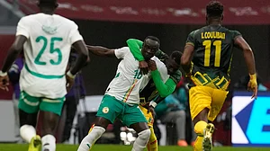 Photo: AP : Mali's Hamari Traore, background, holds Senegal's Sadio Mane during the Africa Cup of Nations quarter-final match in Tangier.