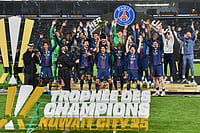 | Photo: AP/Jaber Abdulkhaleg : PSG's Marquinhos holds up the trophy as he celebrates with teammates after the French Super Cup soccer match between PSG and Marseille in Kuwait City, Kuwait.