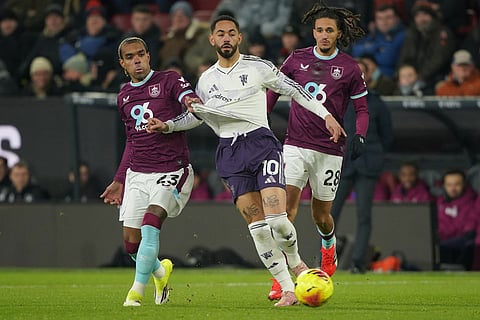 Burnley's Lucas Pires, left, and Manchester United's Matheus Cunha fight for the ball during the Premier League soccer match between Burnley and Manchester United in Wolverhampton, England.