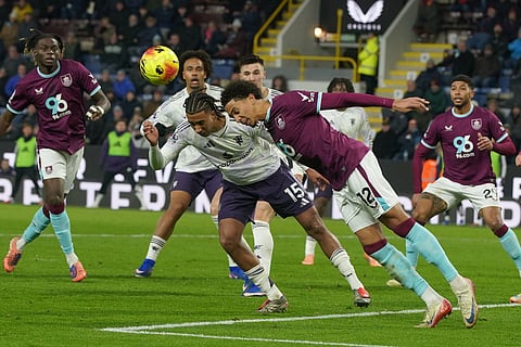 Manchester United's Leny Yoro, left, and Burnley's Bashir Humphreys go for the ball during the Premier League soccer match between Burnley and Manchester United in Burnley, England.