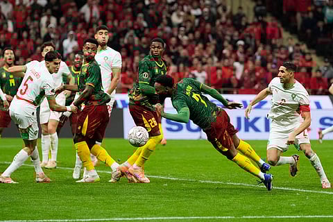 Cameroon's Georges-Kevin N'koudou, center, heads the ball during the Africa Cup of Nations quarterfinal soccer match between Cameroon and Morocco, in Rabat, Morocco.