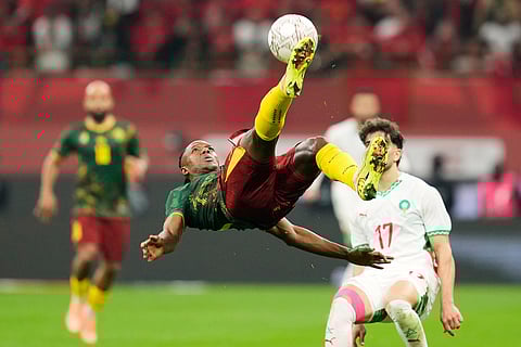 Cameroon's Che Malone, center, is in action during the Africa Cup of Nations quarterfinal soccer match between Cameroon and Morocco, in Rabat, Morocco.