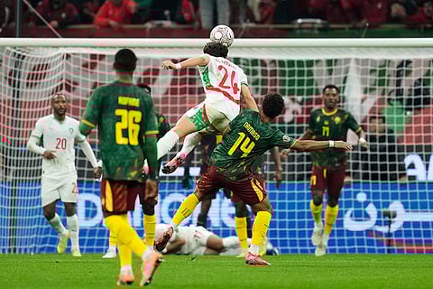 Morocco's Neil Yoni El Aynaoui, center, heads the ball during the Africa Cup of Nations quarterfinal soccer match between Cameroon and Morocco, in Rabat, Morocco.