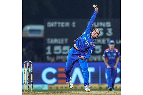 Mumbai Indians’ Amelia Kerr bowls a delivery during a Women's Premier League (WPL) T20 cricket match between Mumbai Indians and Royal Challengers Bengaluru, at the DY Patil Stadium, in Navi Mumbai.