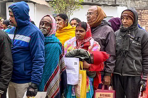 People wait in queues during hearings under the Special Intensive Revision (SIR) of electoral rolls, in Malda district, West Bengal.