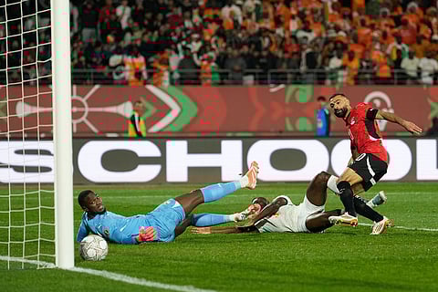Egypt's Mohamed Salah, right, scores his side's third goal during the Africa Cup of Nations quarterfinal soccer match between Egypt and Ivory Coast, in Agadir, Morocco.