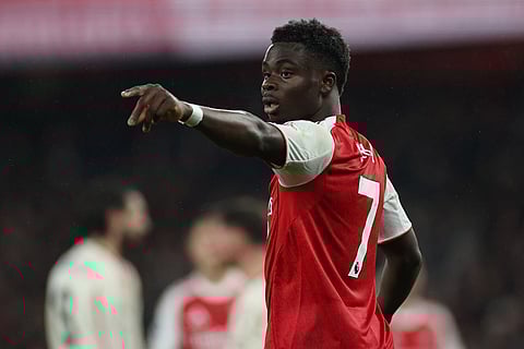 Arsenal's Bukayo Saka reacts during the English Premier League soccer match between Arsenal and Liverpool in London.
