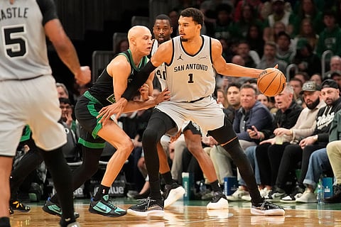 San Antonio Spurs forward Victor Wembanyama (1) is guarded by Boston Celtics guard Jordan Walsh (27) during the first half of an NBA basketball game in Boston.