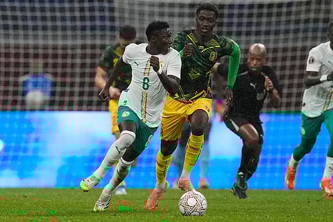 Mali's Mahamadou Doumbia, right, runs to stop Senegal's Lamine Camara during the Africa Cup of Nations quarterfinal soccer match between Senegal and Mali in Tangier, Morocco.